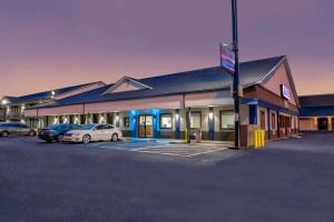 a building with cars parked in a parking lot at Studio 6 Jackson Mississippi I 55 in Jackson