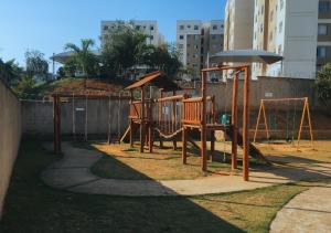 a playground with a swing set in a yard at Apto Inteiro perto da Cidade do Galo e Wi-Fi Rápido in Vespasiano