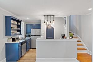 a kitchen with blue cabinets and a white counter top at Quiet Retreat Off Magazine W Balcony & Parking! in New Orleans