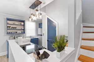 a kitchen with blue cabinets and a blue door at Quiet Retreat Off Magazine W Balcony & Parking! in New Orleans