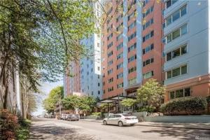 a city street with cars parked in front of tall buildings at Tranquil 2BR downtown condo, Parking, King bed in Seattle