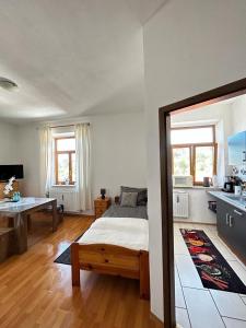a bedroom with a bed and a table in it at Wunderschönes Appartement Nahe der Berge in Bruckmühl +21 photos