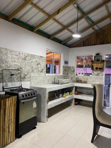 a kitchen with a stove and a counter top at posada sunrise view vacation home in Providencia