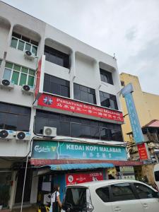 a white building with signs on the side of it at SS HOSTEL PENANG in George Town