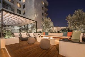 a patio with couches and tables and a building at Hollywood's Best Location with Panoramic Views! in Los Angeles