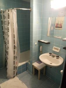 a blue bathroom with a sink and a shower at El Molino in San Carlos de Bariloche