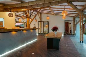 a lobby with a bar with a vase of flowers at Cannatel Exclusive Hotel in La Tebaida