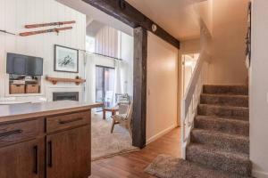 a room with a staircase and a living room at Epic Condo walk to Canyon Lodge in Mammoth Lakes