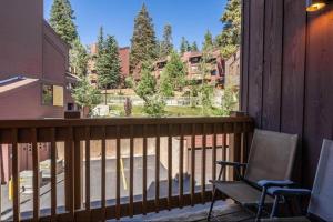 a balcony with a chair and a view of a yard at Epic Condo walk to Canyon Lodge in Mammoth Lakes