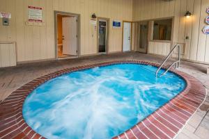 a hot tub in a building with blue water at Epic Condo walk to Canyon Lodge in Mammoth Lakes