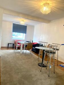 a room with tables and chairs and a projection screen at Elegant single-occupancy double bed room(1 person only) in Morriston
