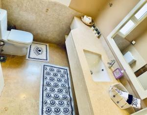 an overhead view of a bathroom with a toilet and a sink at El Gouna Seaduction Breeze ! in Hurghada