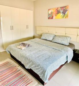 a bedroom with a bed with a blanket and pillows at El Gouna Seaduction Breeze ! in Hurghada