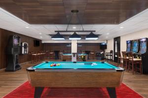 a pool table in a hotel room with a pool table at Holiday Inn Des Moines-Airport Conf Center by IHG in Des Moines