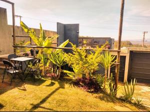 une terrasse avec une table, des chaises et des plantes dans l'établissement Casa (1), à Diamantina