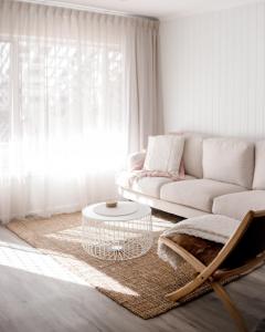 a living room with a couch and a coffee table at Malie - By The Sea in Torquay