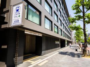 a building with a sign on the side of it at Hyatt Place Kyoto in Kyoto