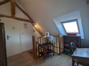 a attic room with a crib and a window at Charmante maison berrichonne restaurée avec jardin, proche de la Vallée de la Creuse et du Lac d'Éguzon - FR-1-591-445 in Maillet +8 photos