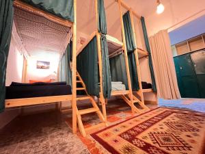 a room with three bunk beds in a room at Mango haus in Aqaba