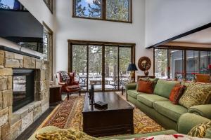 a living room with a couch and a fireplace at Allure at Schaffer's Mill by Tahoe Getaways - 4BR Pet-Friendly Home w Private Hot Tub & Air Conditioning! in Truckee