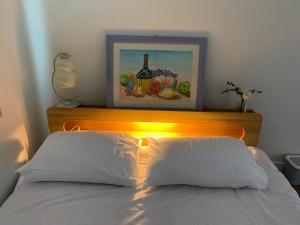 a bed with two white pillows in a bedroom at Miranda House in Jeonju