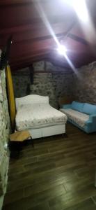 a bedroom with two beds in a stone wall at Su camping in Dağpınar