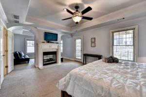 a large bedroom with a bed and a fireplace at Stunning Southern Experience in Atlanta