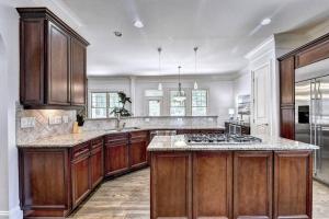 a large kitchen with wooden cabinets and a stove at Stunning Southern Experience in Atlanta