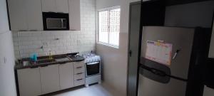 a small kitchen with a stove and a refrigerator at Big apartment close to Allianz Park in Sao Paulo