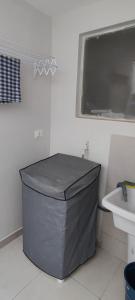 a bathroom with a large gray trash can next to a sink at Big apartment close to Allianz Park in Sao Paulo