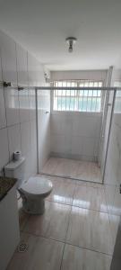 a white bathroom with a toilet and a window at Big apartment close to Allianz Park in Sao Paulo