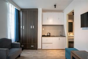 a living room with a couch and a kitchen at Sonder - Tan Son Nhat Airport Hotel in Ho Chi Minh City