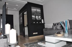 a living room with a couch and a table at Val Fleuri Apartment with 2 Balconies, Casablanca in Casablanca