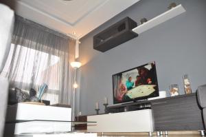 a living room with a flat screen tv on a wall at Val Fleuri Apartment with 2 Balconies, Casablanca in Casablanca