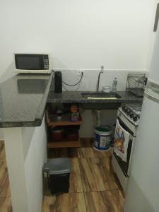 a kitchen with a counter and a sink and a stove at Casa mirante Bela Vista in Guarujá
