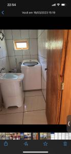 a small bathroom with a toilet and a sink at Cabanas Romeu & Julieta in Cambara do Sul