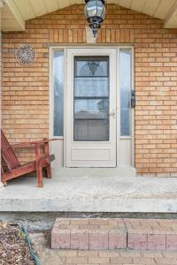 a door of a house with a bench next to it at KD Bachelor Suite - Lower Level in Barrie