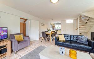 a living room with a couch and a table at Oesterbaai 8 Personen in Wemeldinge