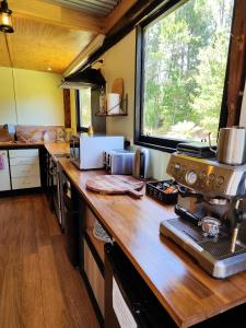 a kitchen with a large wooden counter top at Glamping at Zeehan Bush Camp in Zeehan