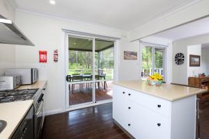 a kitchen with white cabinets and a counter top at Serenity Halls Gap 2 Absolute NP Frontage in Halls Gap