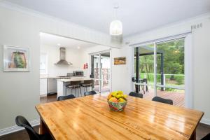 a dining room with a wooden table with a bowl of fruit at Serenity Halls Gap 2 Absolute NP Frontage in Halls Gap