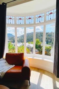 a room with a large window with a couch in front at Luxury Hobart City Fringe Home in Hobart