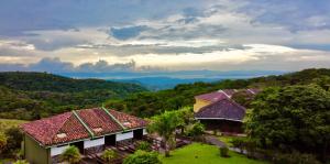 an aerial view of a house with mountains in the background at Hotel Montaña Monteverde in Monteverde Costa Rica