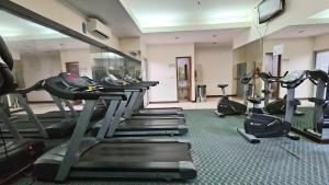 a gym with a row of treadmills and machines at Amazing view Apartment at Kemayoran JIEXPO -Min Stay 3 nights- in Jakarta