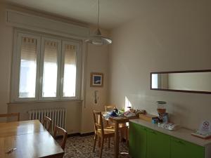 ein Esszimmer mit einem Tisch, einem Tisch und Stühlen in der Unterkunft B&B Casa Fuori Casa 200 mt dal casello autostradale in Senigallia