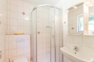 a bathroom with a shower and a toilet and a sink at Haus Moser in Wörschach