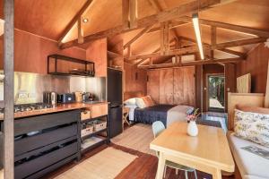 uma cozinha e sala de estar numa pequena casa em The Shed Guest House em Mount Maunganui