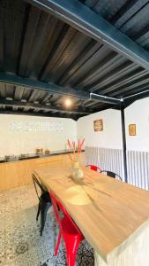 a wooden table with red chairs in a room at Sampai Villa Ruang Tepi in Yogyakarta