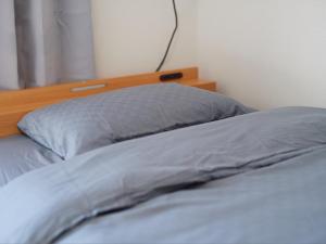 Postel nebo postele na pokoji v ubytování Tabist A Mirai Oji