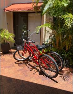 two red bikes parked in front of a house at Wala Villa in Noosaville